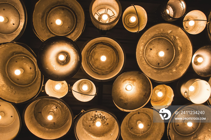 light on Night with a lot of vintage lamps and candles on iron bucket