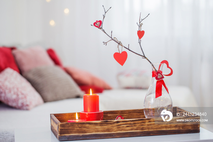 Burning candles on white table in interior. Valentines day concept