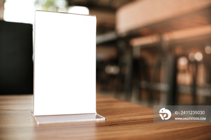 Mock up Menu frame standing on wood table in Bar restaurant cafe. space for text