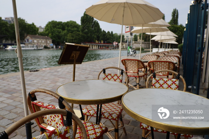 parisian cafe terrace on canal embankment