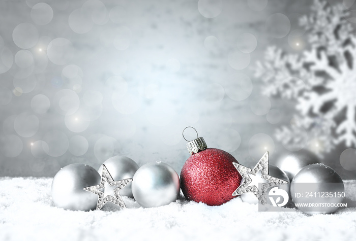 Christmas balls on snow silver background. Greeting card.