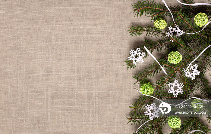 Fir tree branch with ratan balls and snowflakes