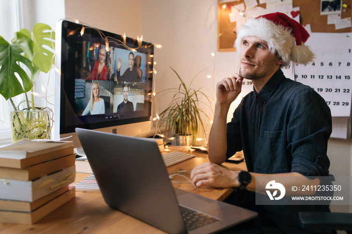 Business video conferencing. Young man having video call via computer in the home office. Virtual Ch