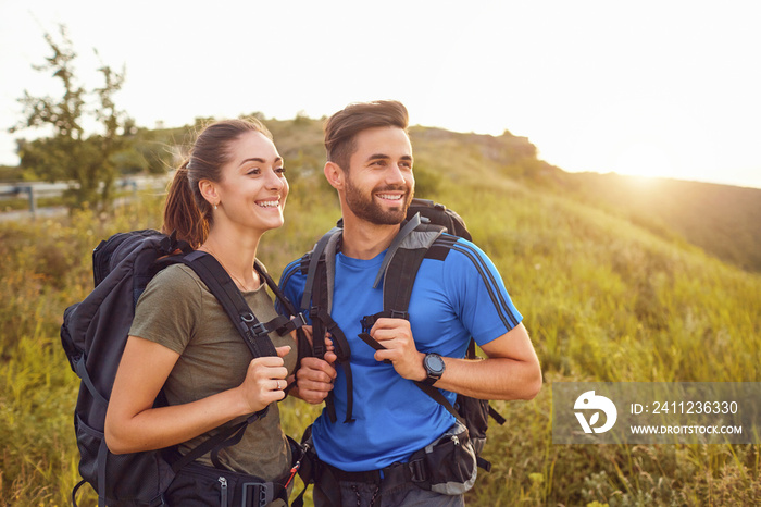 Happy couple of tourists  smiling in nature.