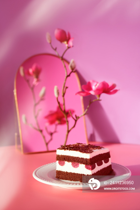 Chocolate cake with cherries. Piece of cake on a plate with fork. Bottle of pink vine reflected in a