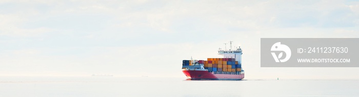 Large cargo container ship sailing in an open Baltic sea on a clear day. Freight transportation, nau