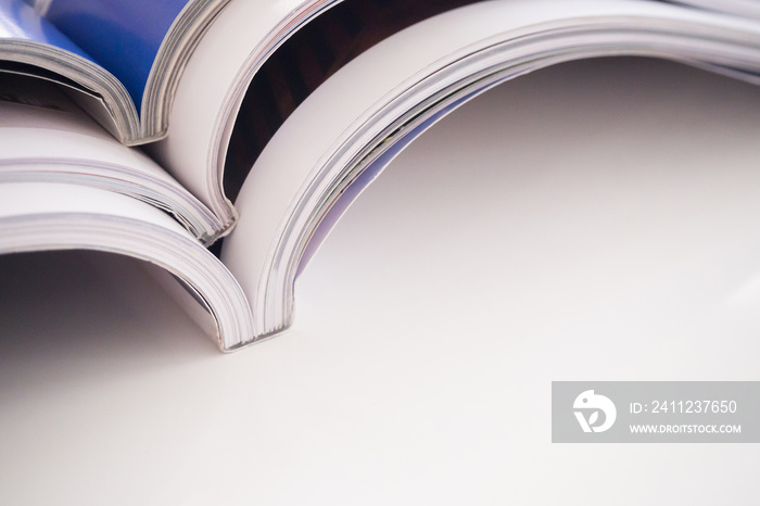 pile of magazines stack on white table in living room