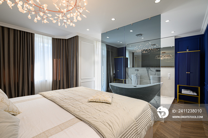 Big comfortable double bed in elegant classic bedroom