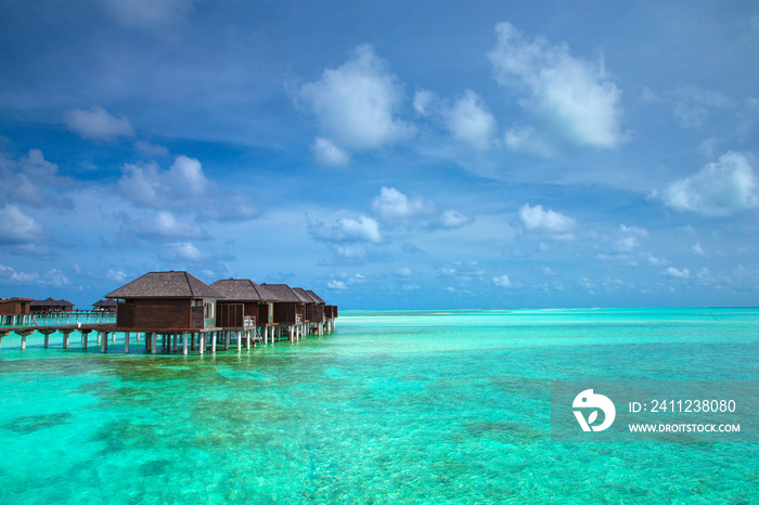 Beautiful tropical Maldives island with beach. Sea with water bungalows