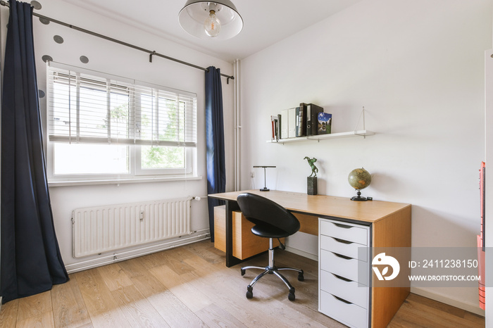 Minimalist interior of study room with parquet floor and white walls furnished with settee and table