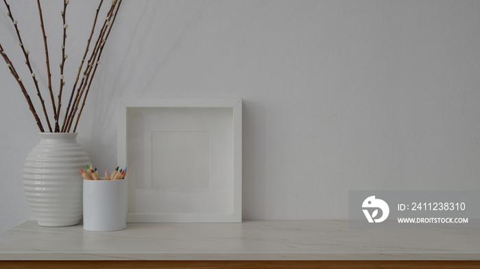 Close up view of minimal workspace on marble table with white wall