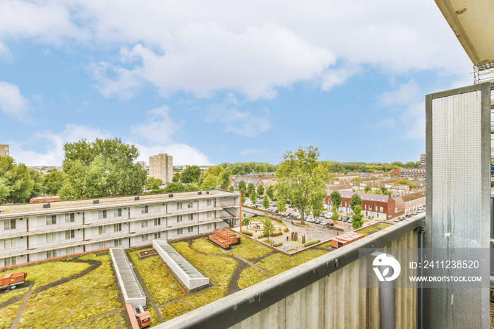 a green roof on a building in portland, oregon with blue sky and white clouds overhead view from the