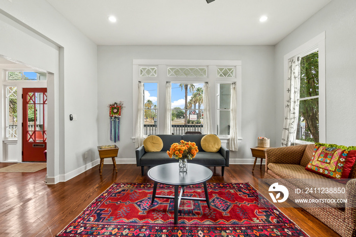 a living room with a large red rug