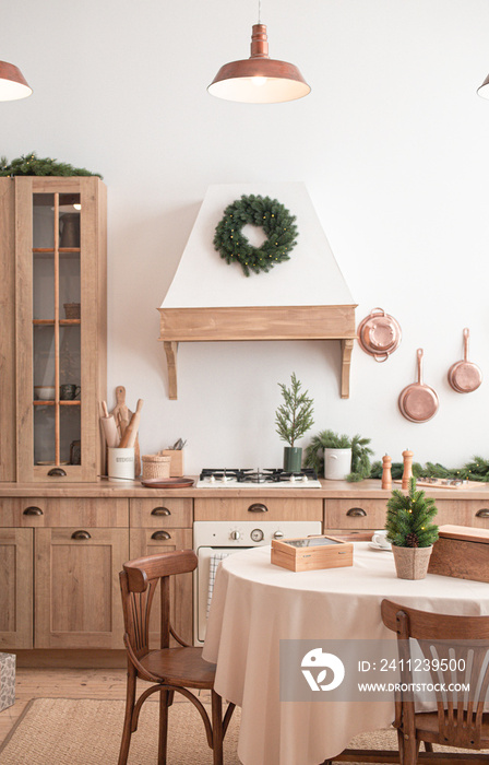 Modern, light, festive, cozy kitchen interior with Christmas and New Year decorations, kitchen table