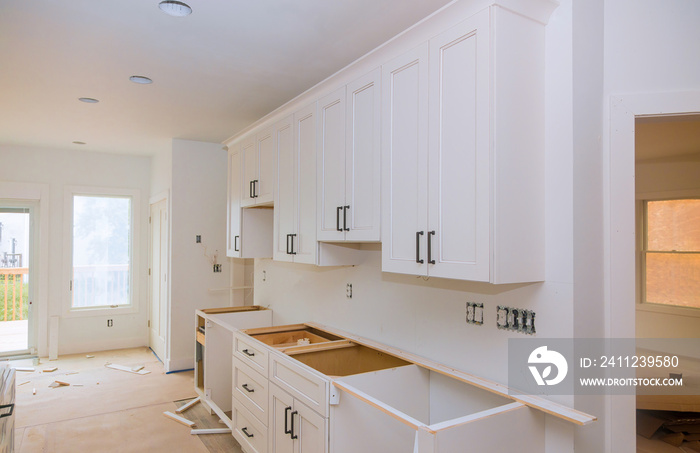 Custom kitchen cabinets in various stages of installation base