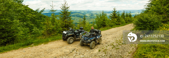 Excited young woman on quad bike. Happy young woman driving all terrain vehicle in nature.