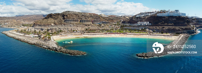 Aerial drone photo. Playa de Amadores, large cove with a white sand beach. Puerto Rico de Gran Canaria, Canary Islands, Spain.