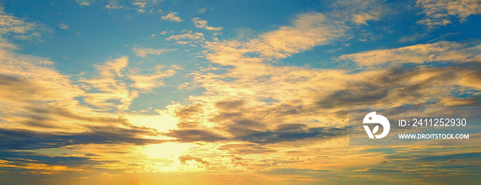 Beautiful Sunset in the sky with sky blue and orange light of the sun through the dark clouds in the sky, Orange and red dramatic colors - Image