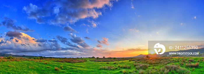 Colorful Summer sunset with sun rays coloring the clouds