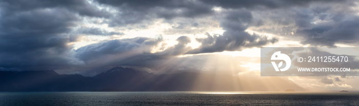 Beautiful Panoramic View of American Mountain Landscape on the Ocean Coast during a cloudy and colorful sunrise in fall season. Taken in Glacier Bay National Park and Preserve, Alaska, USA.