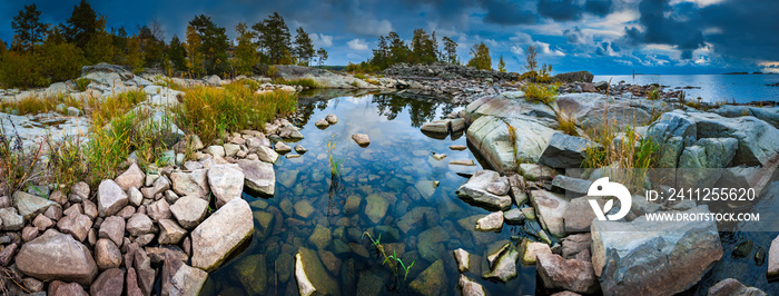 Russia. Karelia. The rocky shore of the island. Rocky river. Large stones flooded with water. Karelian landscape. Wildlife panorama. Stony shore on Lake Ladoga. Ladoga lake.