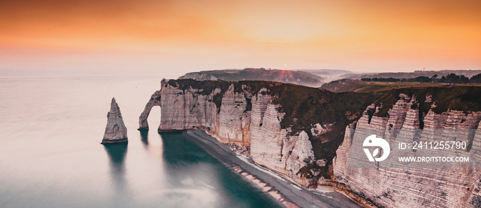 coastal landscape along the Falaise d’Aval the famous white cliffs of Etretat village, with the Porte d’Aval natural arch and the rock known as the Aiguille d’Etretat