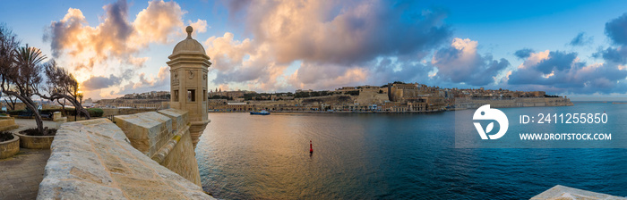 Senglea, Malta - Sunset and panoramic skyline view at the watch tower of Fort Saint Michael, Gardjola Gardens with beautiful sky and clouds