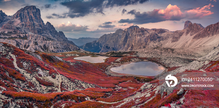 Beautiful autumn scenery. Colorful sunrise in rocky mountain valley. Amazing morning scene of Tre Cime di Lavaredo National park with Laghi del Piani lakes, Dolomiti Alps, Italy, Europe.