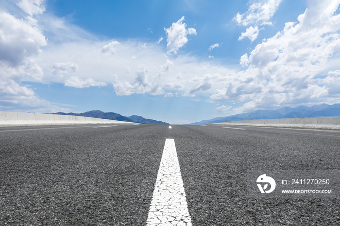 Straight highway and mountain natural scenery under blue sky.Landscape and highway.Outdoor road background.