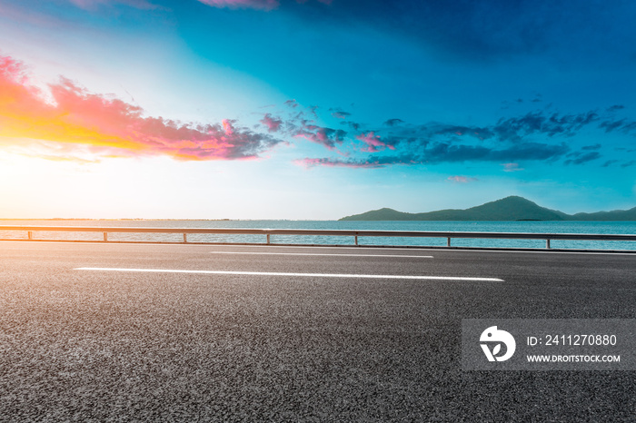 empty asphalt highway and blue sea nature landscape at sunset