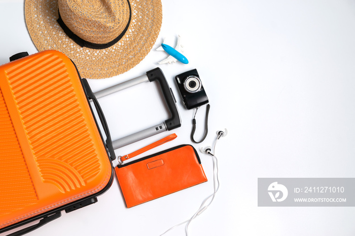 Flat lay orange suitcase with traveler accessories on white background. travel, summer and holiday concept