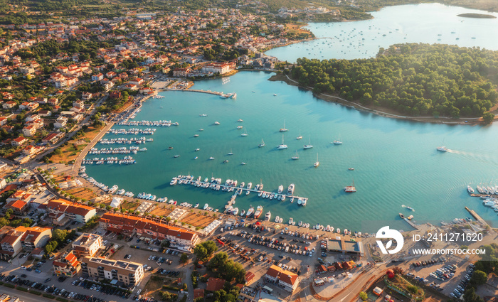 Beautiful Medulin city aerial view. Top view from drone of coastline at sunset with yachts, colorful seascape, Croatia