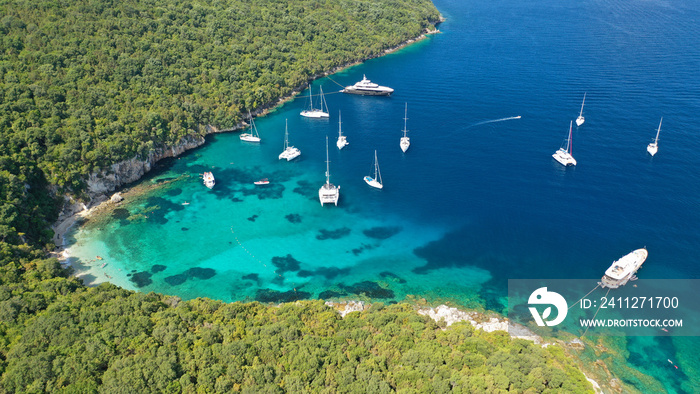 Aerial drone photo of limestone tropical exotic island bay with crystal clear turquoise sea visited by yachts and sail boats in popular paradise destination