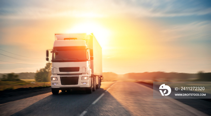 Truck with container on highway with sun light. Concept cargo transportation banner. Blur move effect