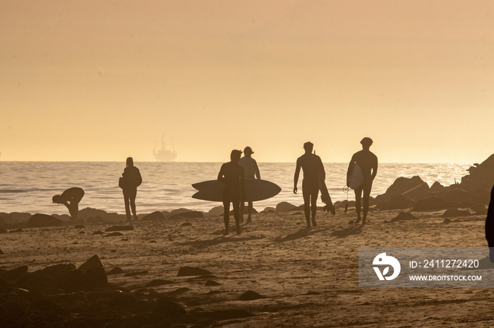 Surfing Rincon point in California in the winter at sunset