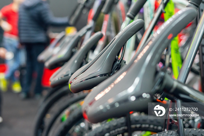 Bicycle saddle, rows of bicycles in a sports shop