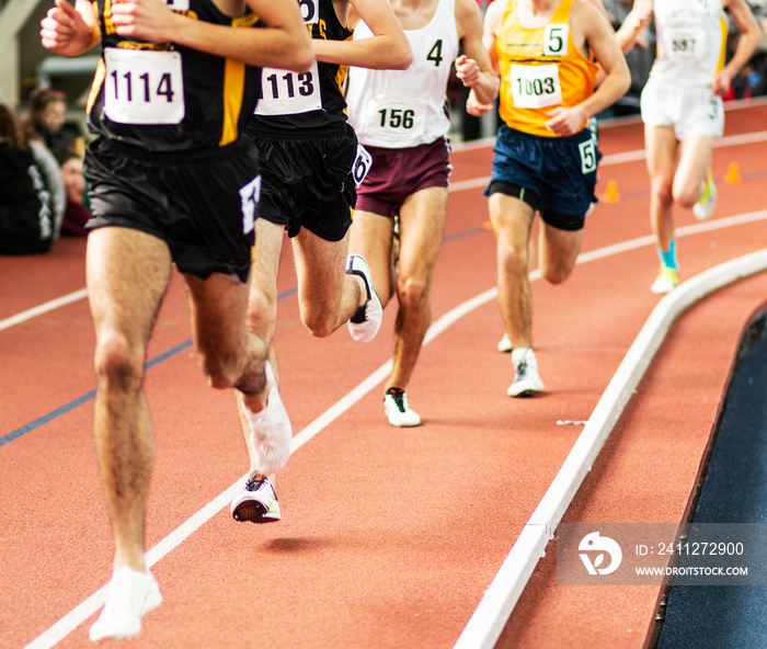 Runners racing in a straight line on an indoor track