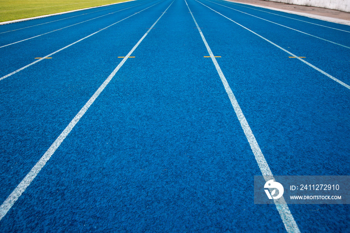 Blue running track in stadium. rubber running tracks in outdoor stadium.