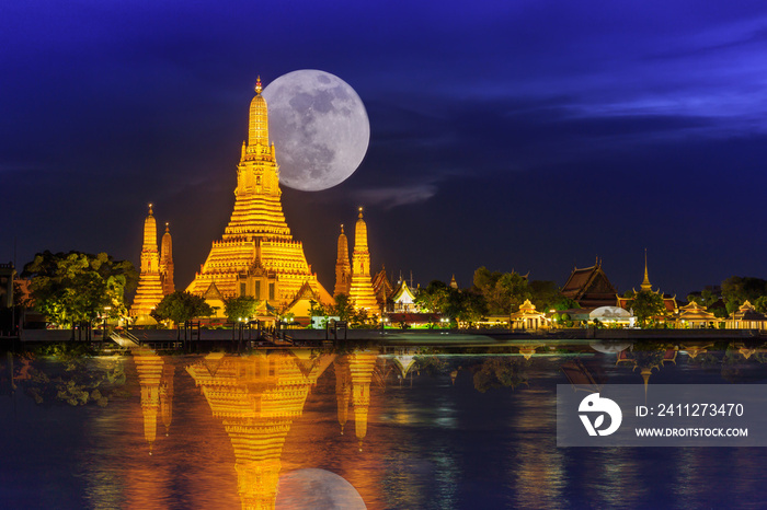 Wat arun in night with super full moon,Wat Arun at night with Light gold is the oldest temple of the Chao Phraya River and Full moon In the dark sky in Bangkok Thailand