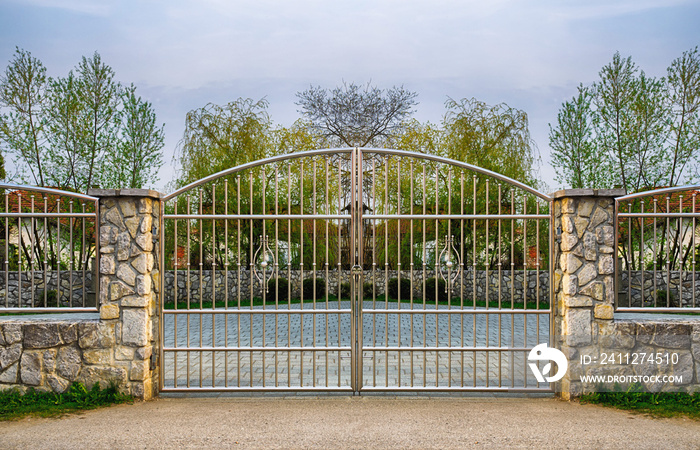 Chrome fence gate. Chromium Stainless steel fence on stone wall