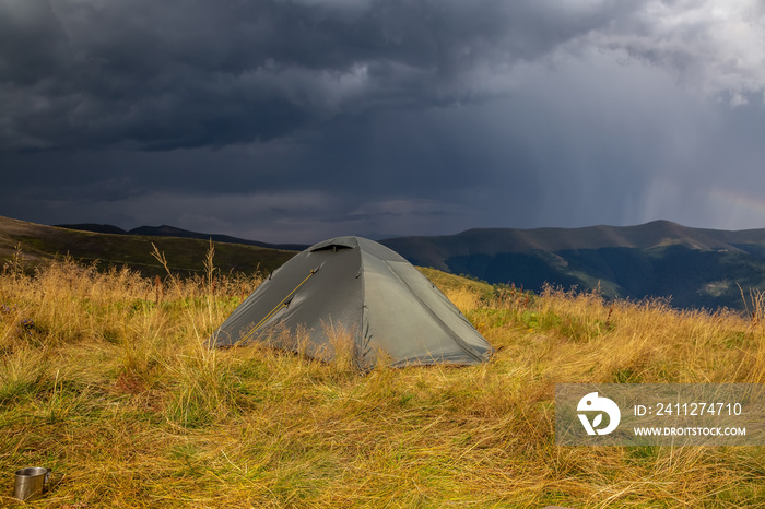 Beautiful mountain landscape in stormy weather with a tourist tent. Carpathian mountains of Ukraine. Holidays in the mountains.