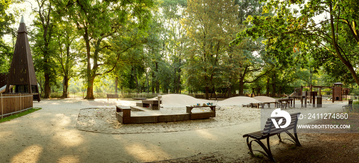 Beautiful playground with wooden equipment in a city park