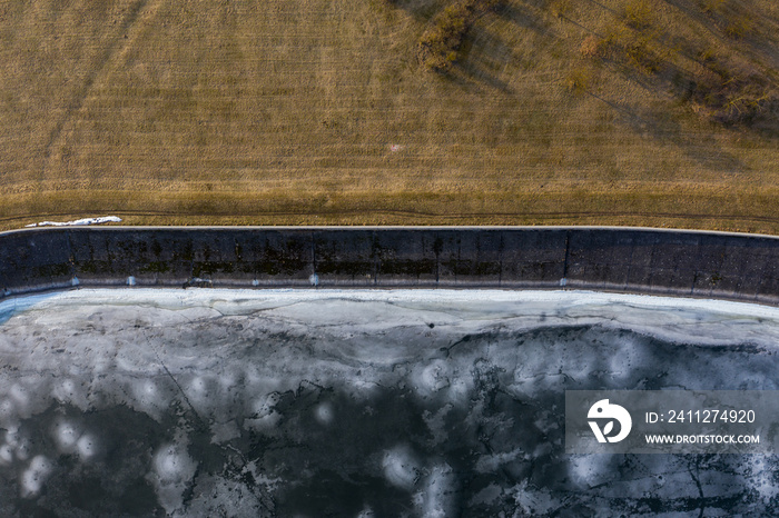 Aerial view of frozen lake coastline in winter