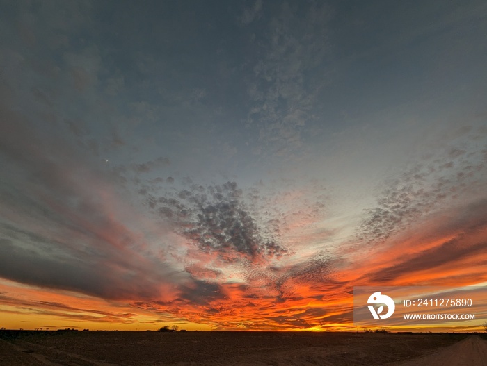 fire in the sky; fire orange sunset in west texas; wide landscape sunset and cloudscape