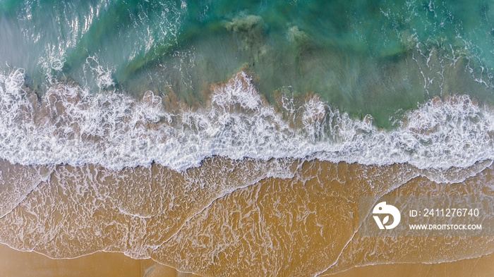 Top view from sky of sea wave and sand beach landscape.