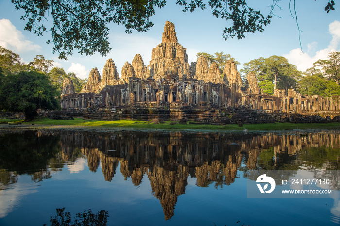 The spectacular reflection of Bayon a mountain temple built to represent Mount Meru, the center of the universe in Hindu and Buddhist cosmology, Siem Reap of Cambodia.