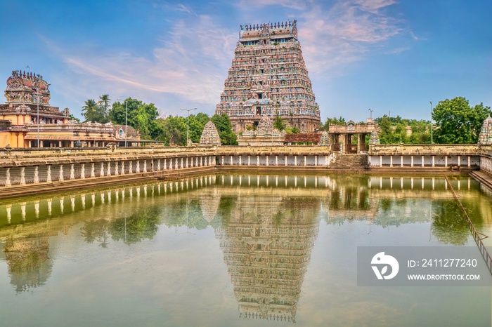 A large water pool reflecting the majestic tower of Nataraja Temple in Chidambaram, Tamil Nadu, South India.