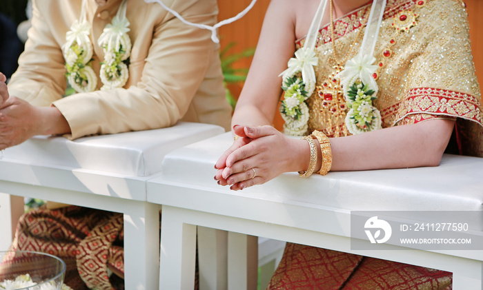 Thai wedding ceremony. Bride and groom hands.