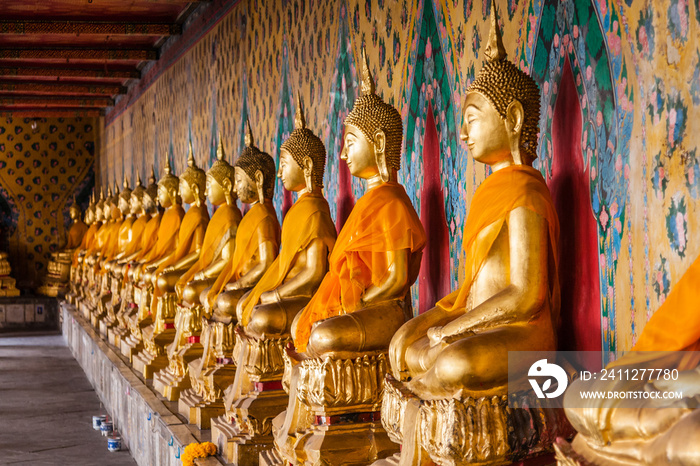 A gallery of the statues of dressed seated Buddhas in Wat Arun, Bangkok