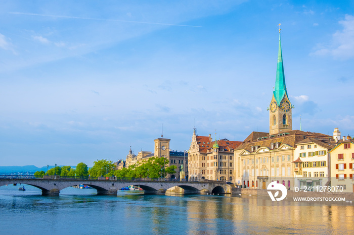 Scenic panoramic view of historic Zürich city center with famous Fraumünster and Grossmünster Church and river Limmat at Lake Zurich on a beautiful sunny day with blue sky in summer, Switzerland